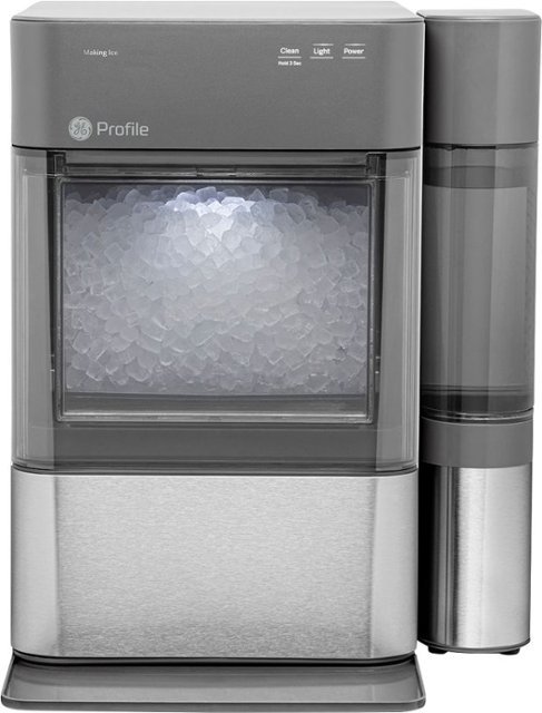 A gray and stainless steel GE Profile ice maker with a transparent front display showing ice, and a tall water reservoir on the right side.