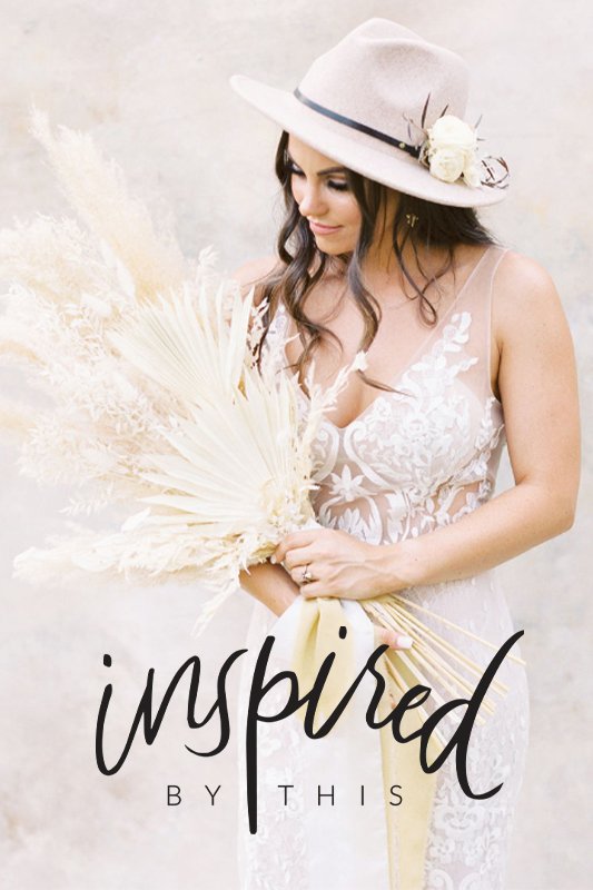 A woman in a white lace dress and beige hat holds a bouquet of dried flowers. The words "inspired by this" are written at the bottom of the image.