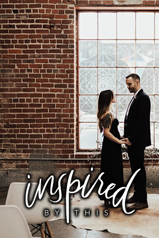 A couple holding hands and facing each other in front of a large window with a brick wall backdrop. The text "inspired by this" is overlaid at the bottom of the image.