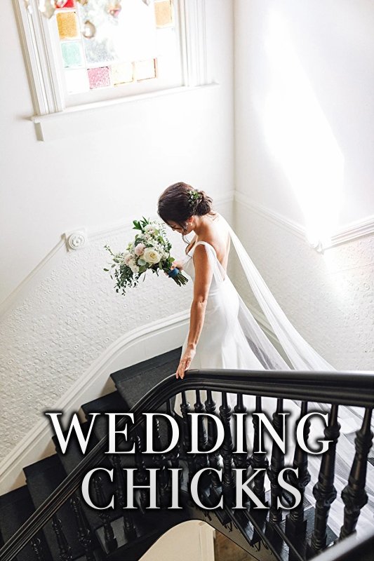 A bride in a white dress and veil descends a staircase while holding a bouquet of flowers. The text "WEDDING CHICKS" is overlaid on the image.