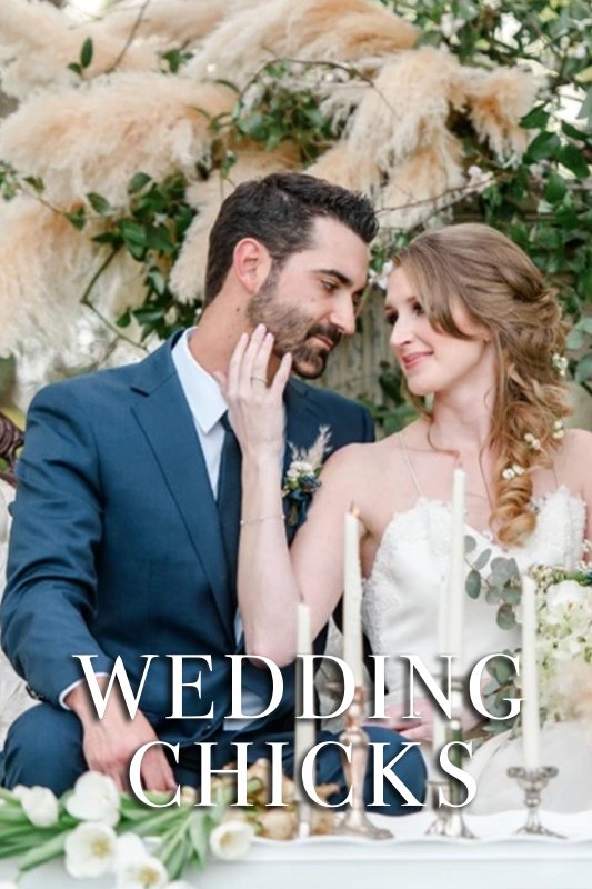 A bride and groom sit closely together at a wedding reception table adorned with candles and flowers. The words "WEDDING CHICKS" are overlaid on the image.