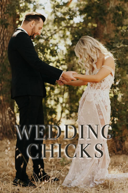 A couple stands in a forest clearing holding hands in wedding attire. "Wedding Chicks" is written in large text over the bottom of the image.