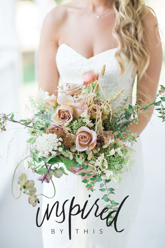 Bride in white lace dress holding a bouquet of pink roses and greenery. Text overlay reads "Inspired by This.