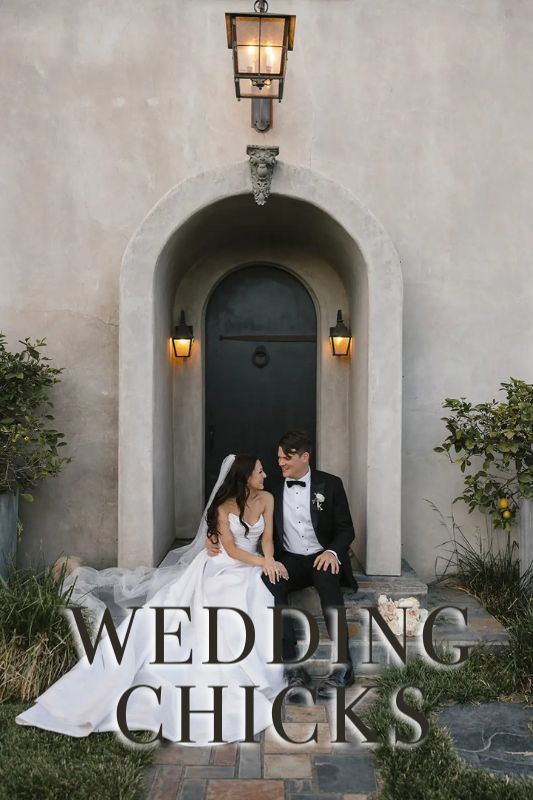 A bride and groom in formal attire sit together in front of an arched doorway with lanterns, and the text "WEDDING CHICKS" is overlaid at the bottom.